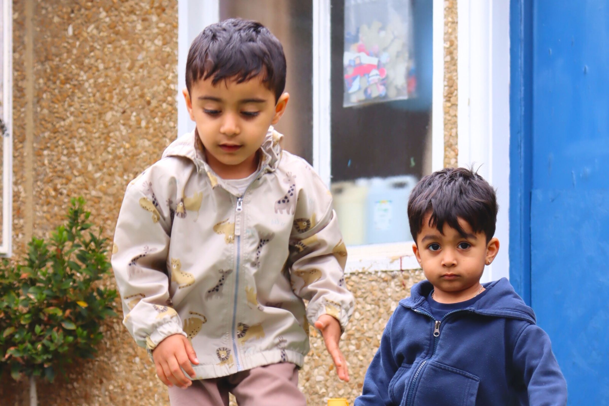 Toddlers playing in the nursery garden, enjoying the outdoors