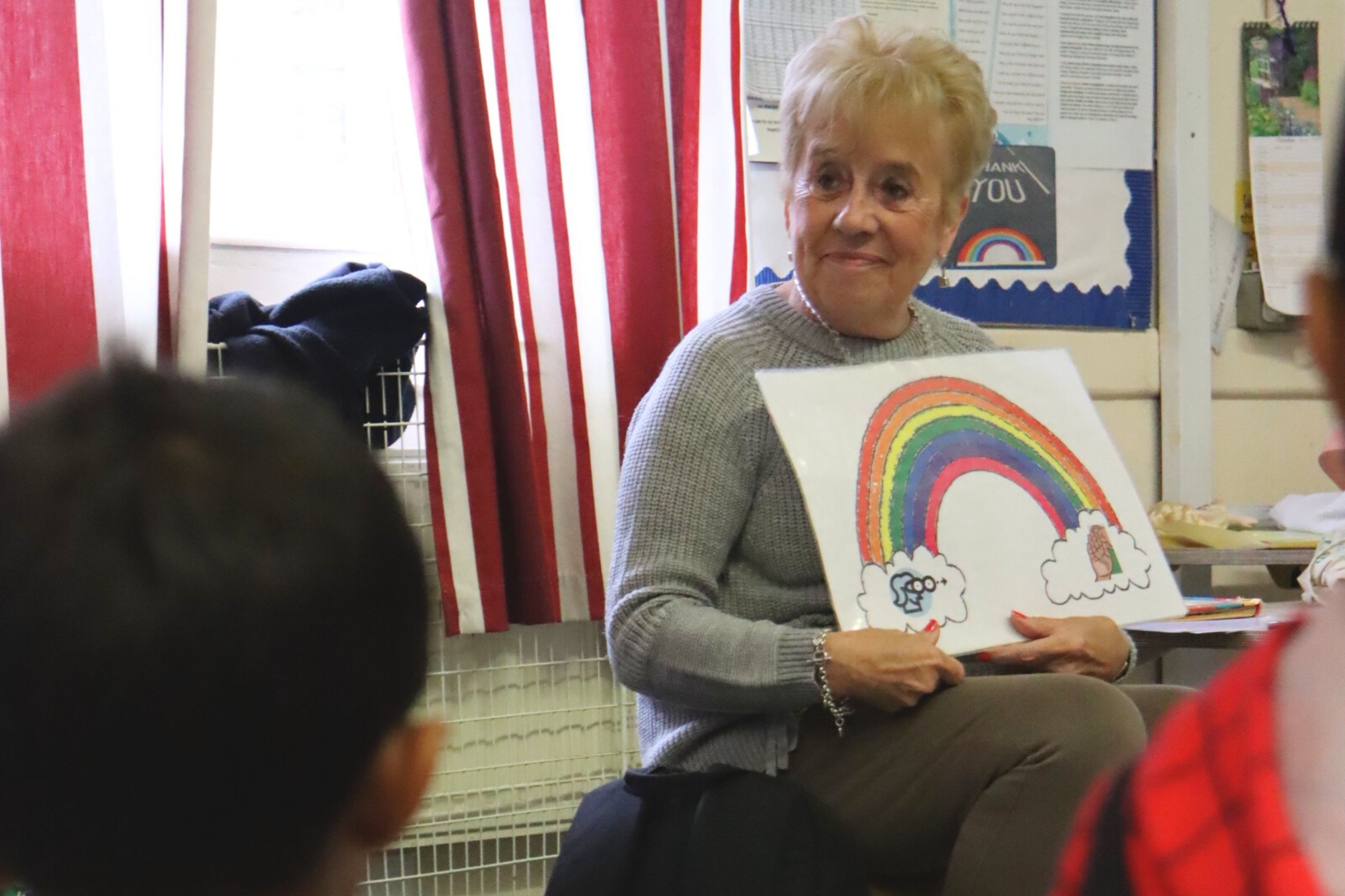 The French teacher conducting a session with smiling budding learners