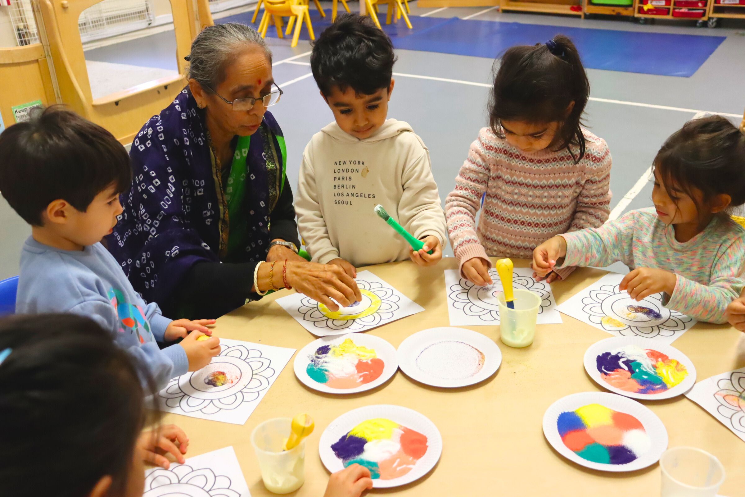 A visiting grandmother leading a special Diwali session with budding learners