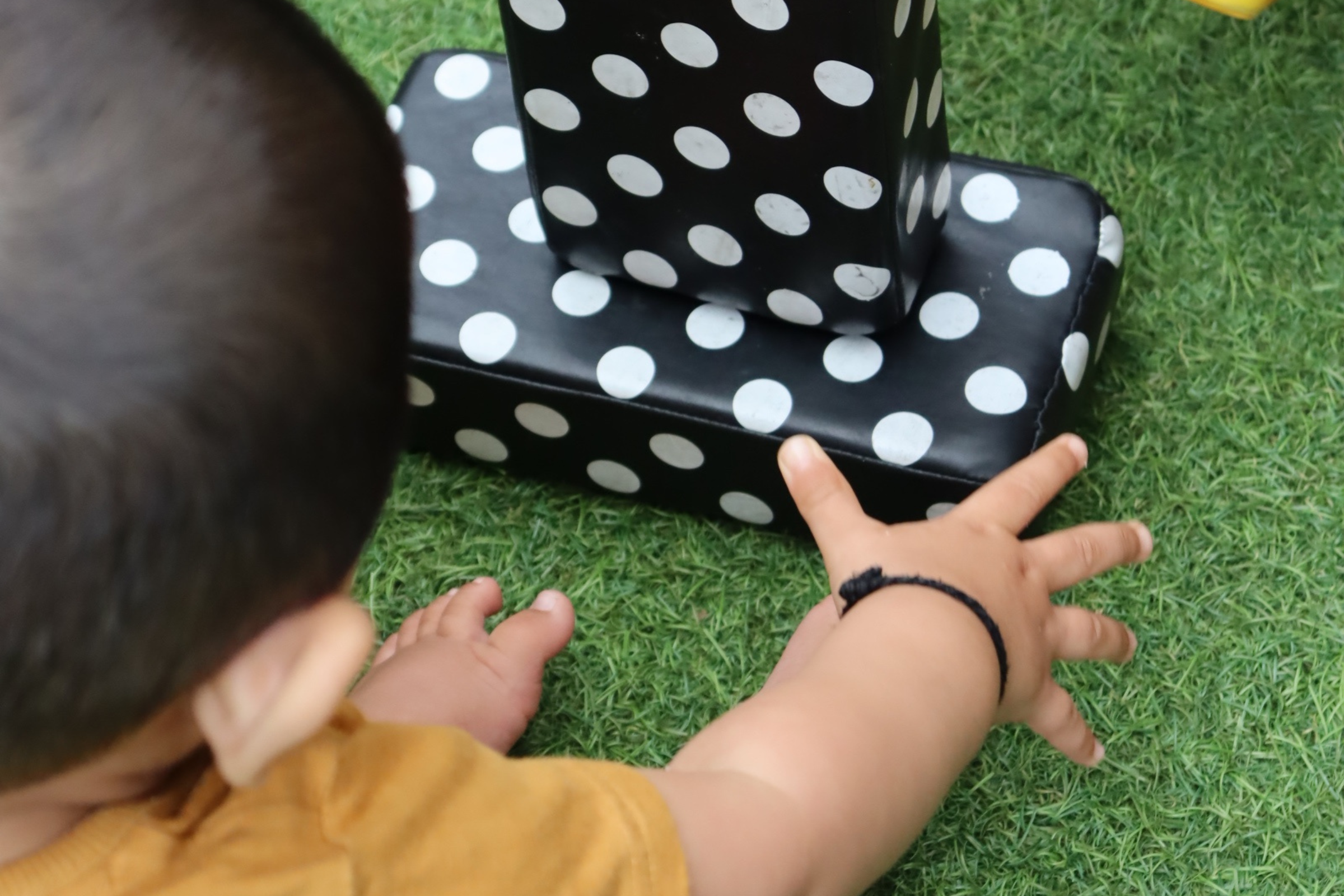 one of Budding Learners babies captured from the back whilst doing a Montessori activity