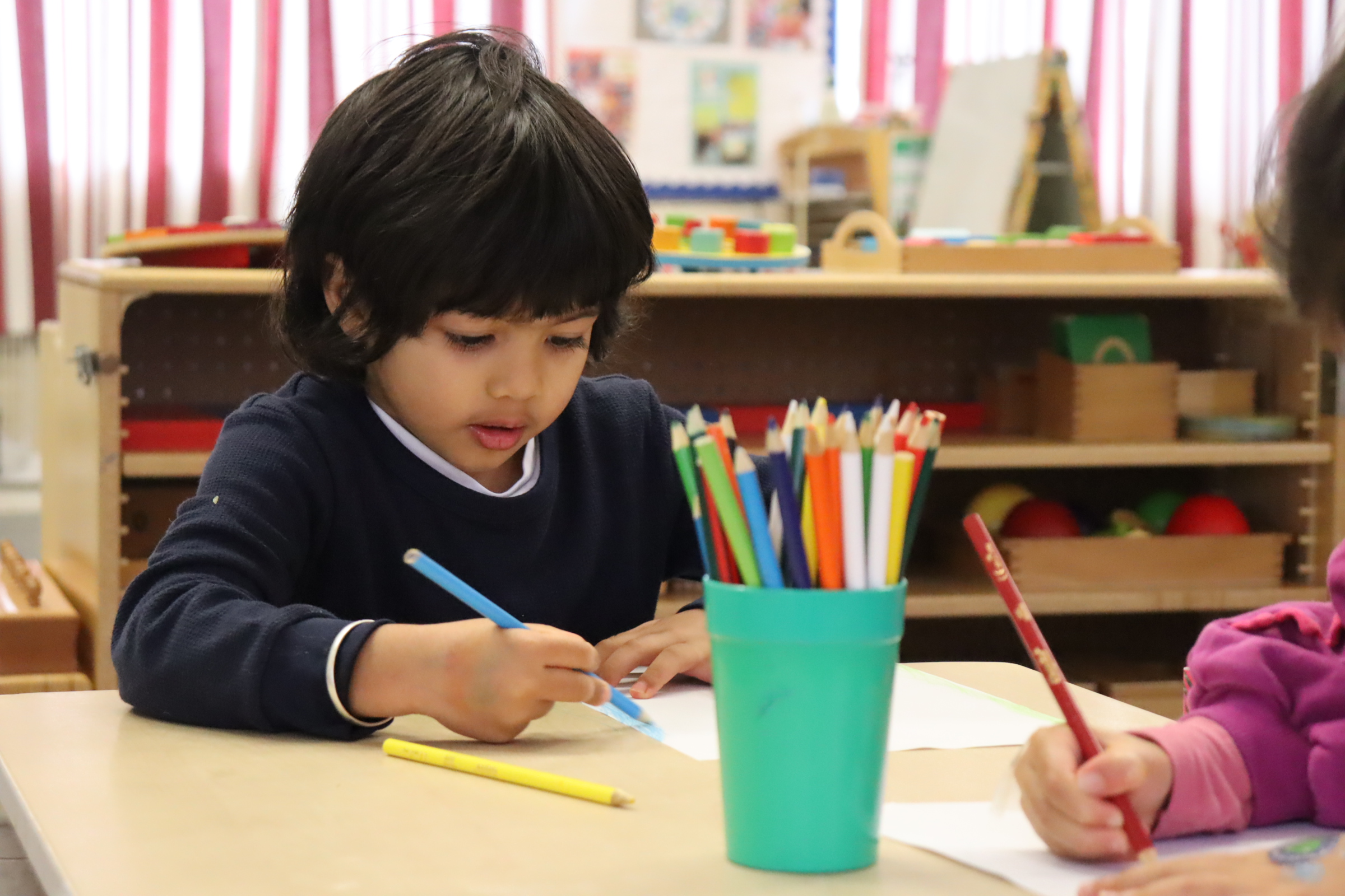 A Budding Learner's preschooler drawing during the morning free session