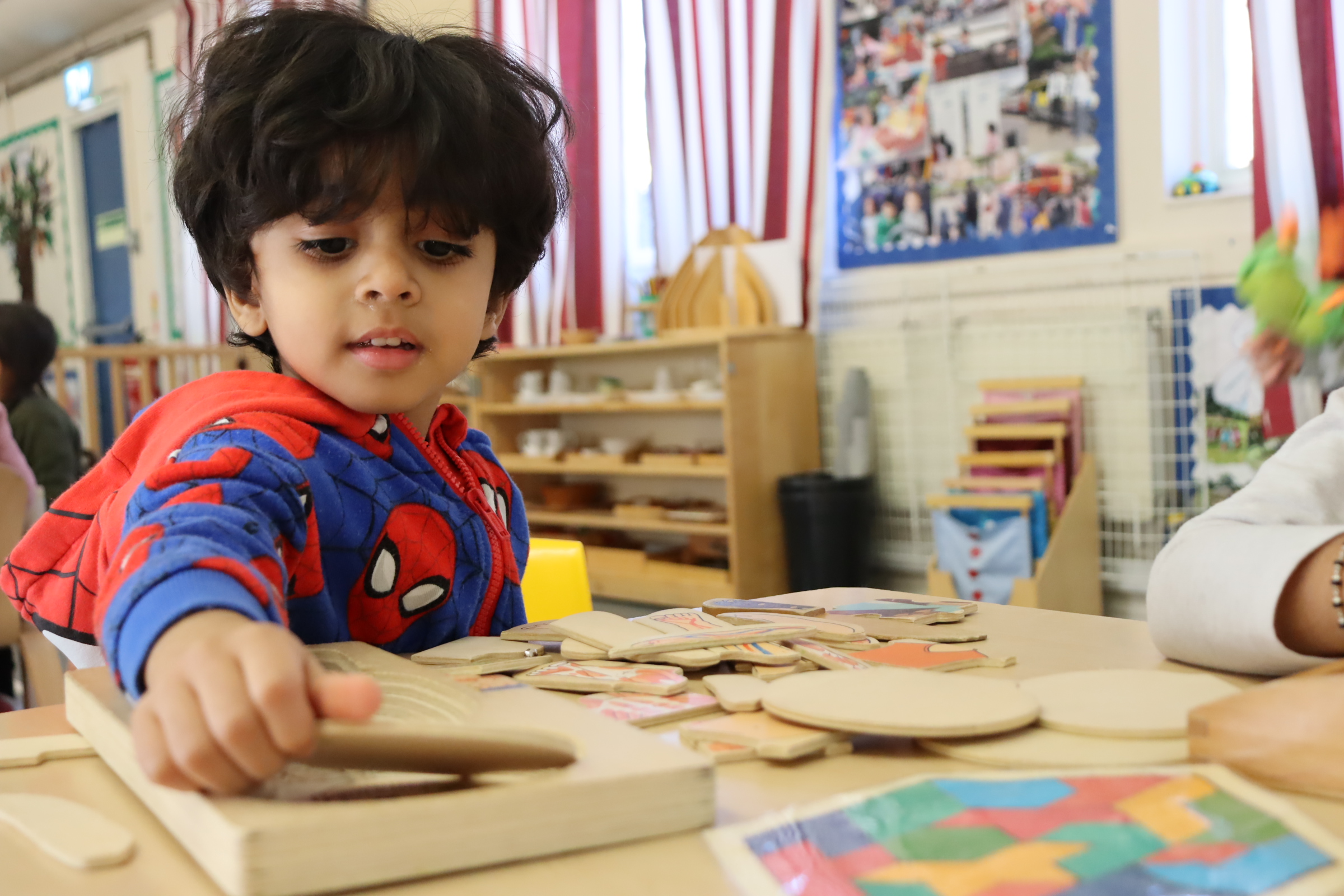 a Budding Learner's preschooler working on a Montessori activity on his own