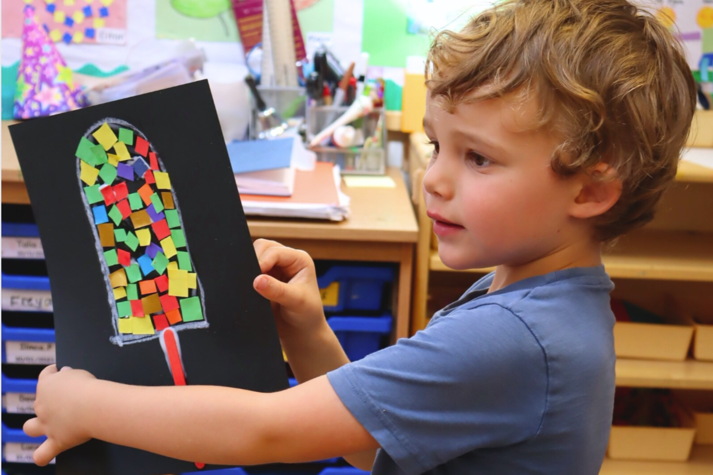 preschooler showing his art