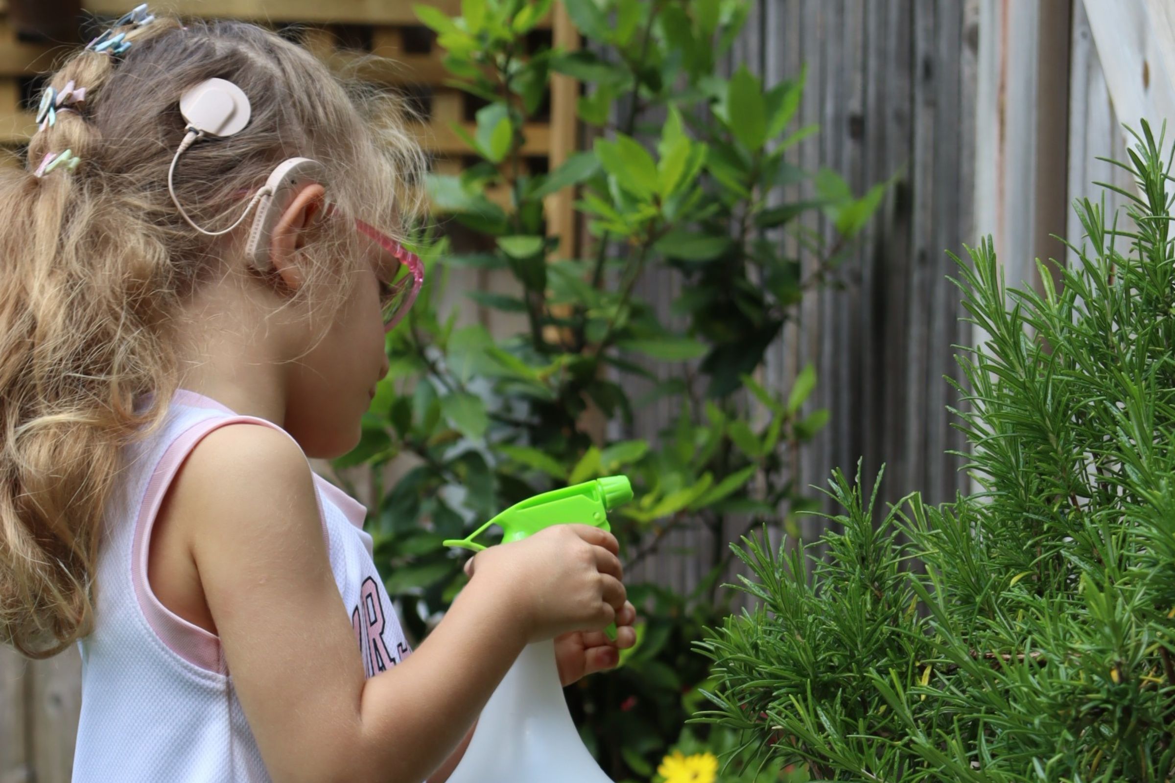 A Great learner watering plants in the nursery's garden