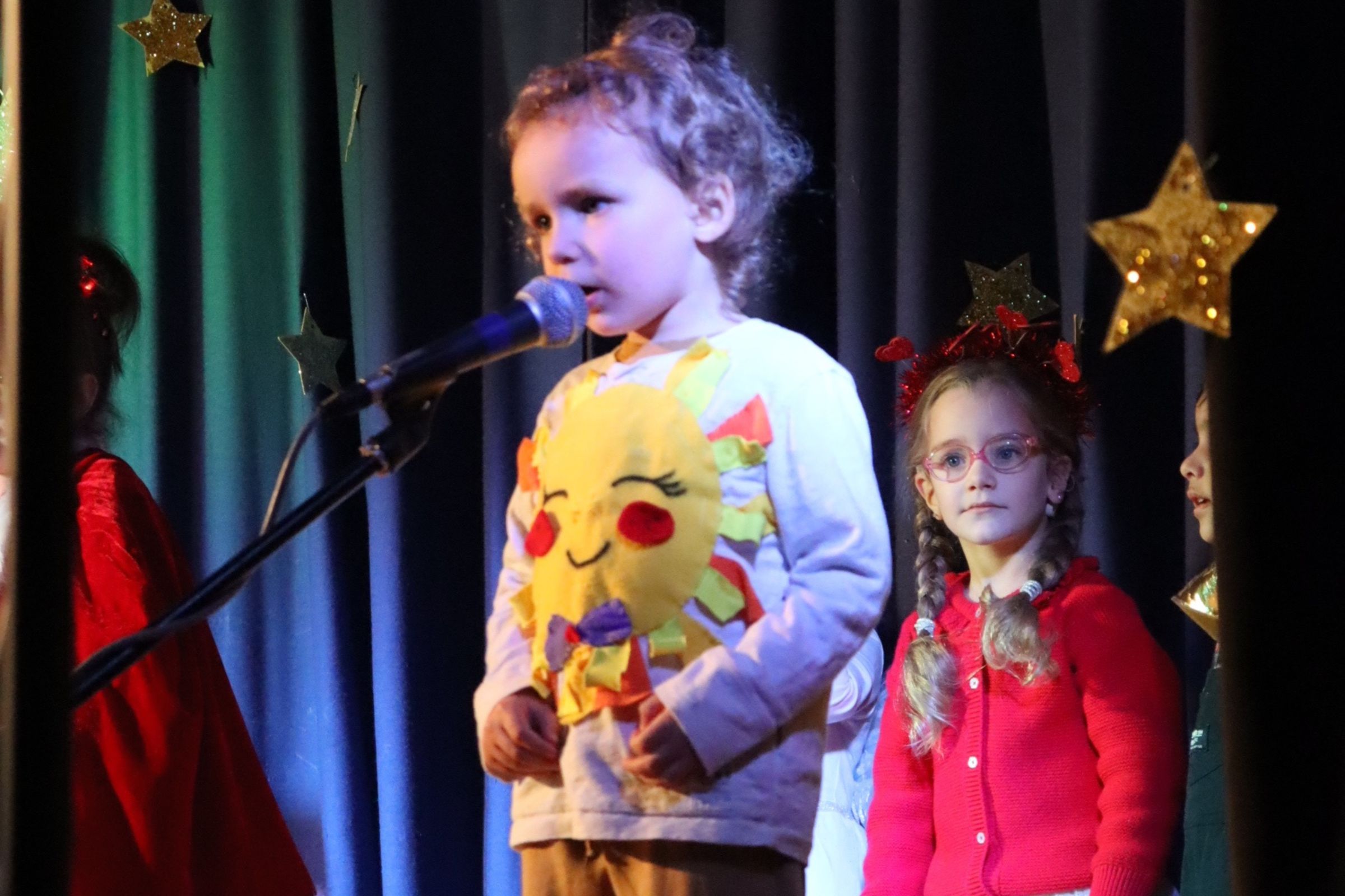 A preschooler presenting his part during the annual Christmas show