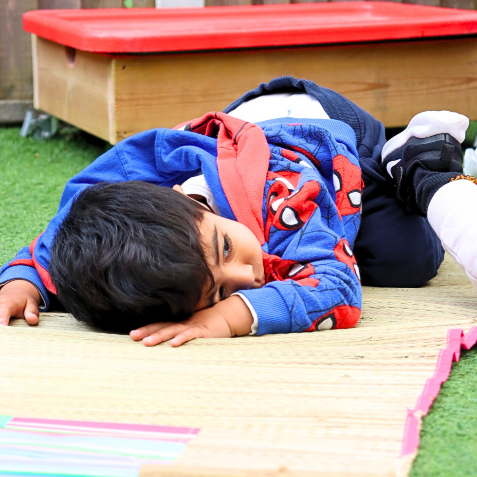A great learner playing in his crib
